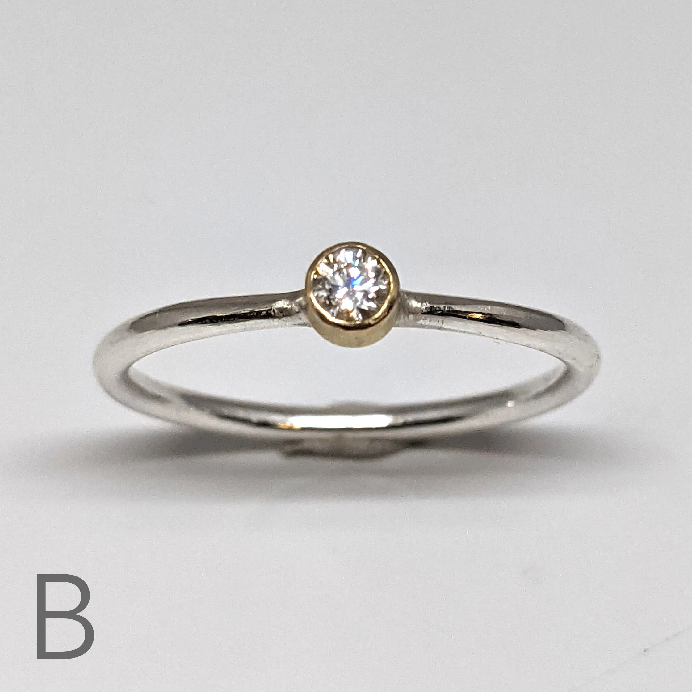 NEW! Moissanite with an 18kt Gold Bezel on a Sterling Silver Stacking Rings by Thea Izzi