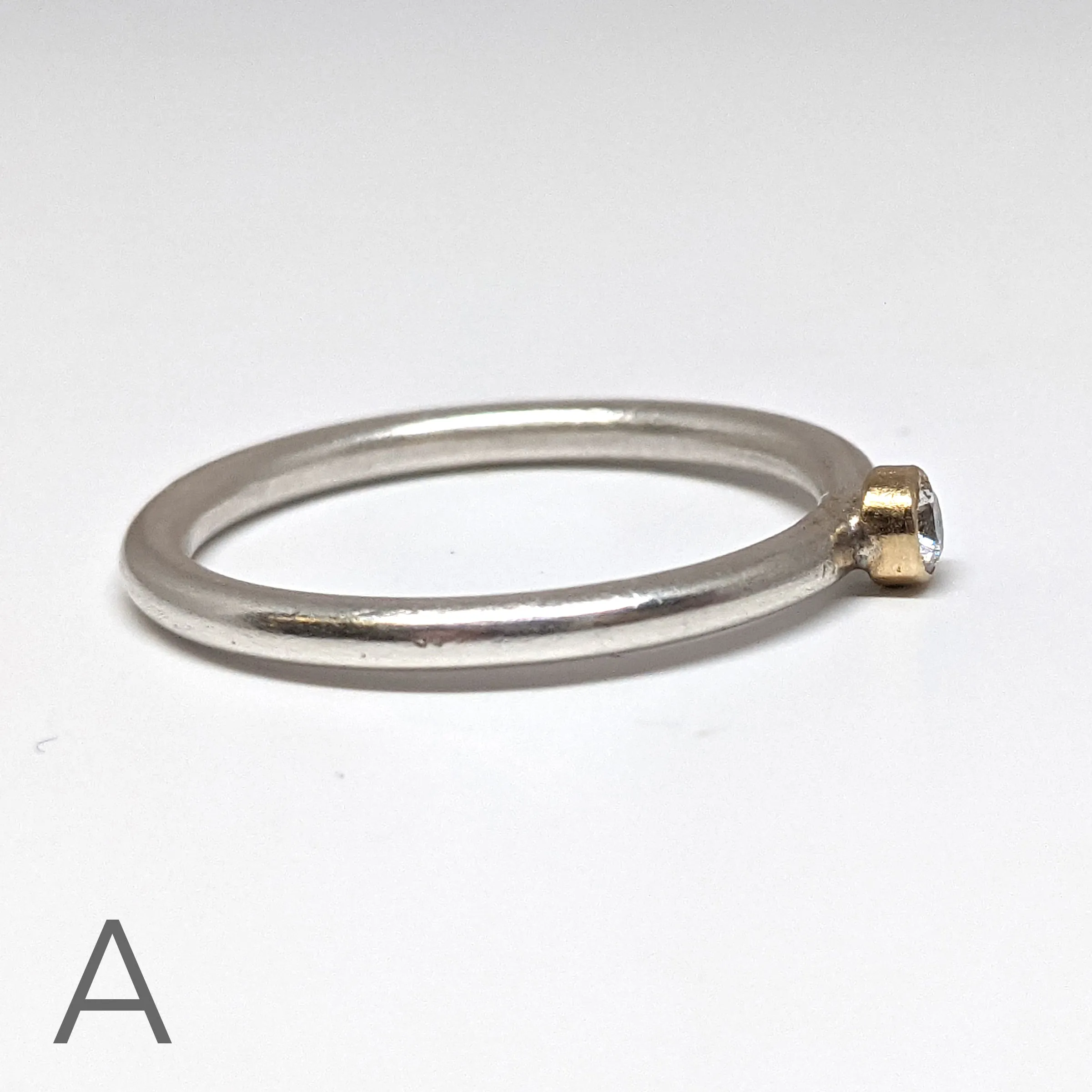 NEW! Moissanite with an 18kt Gold Bezel on a Sterling Silver Stacking Rings by Thea Izzi