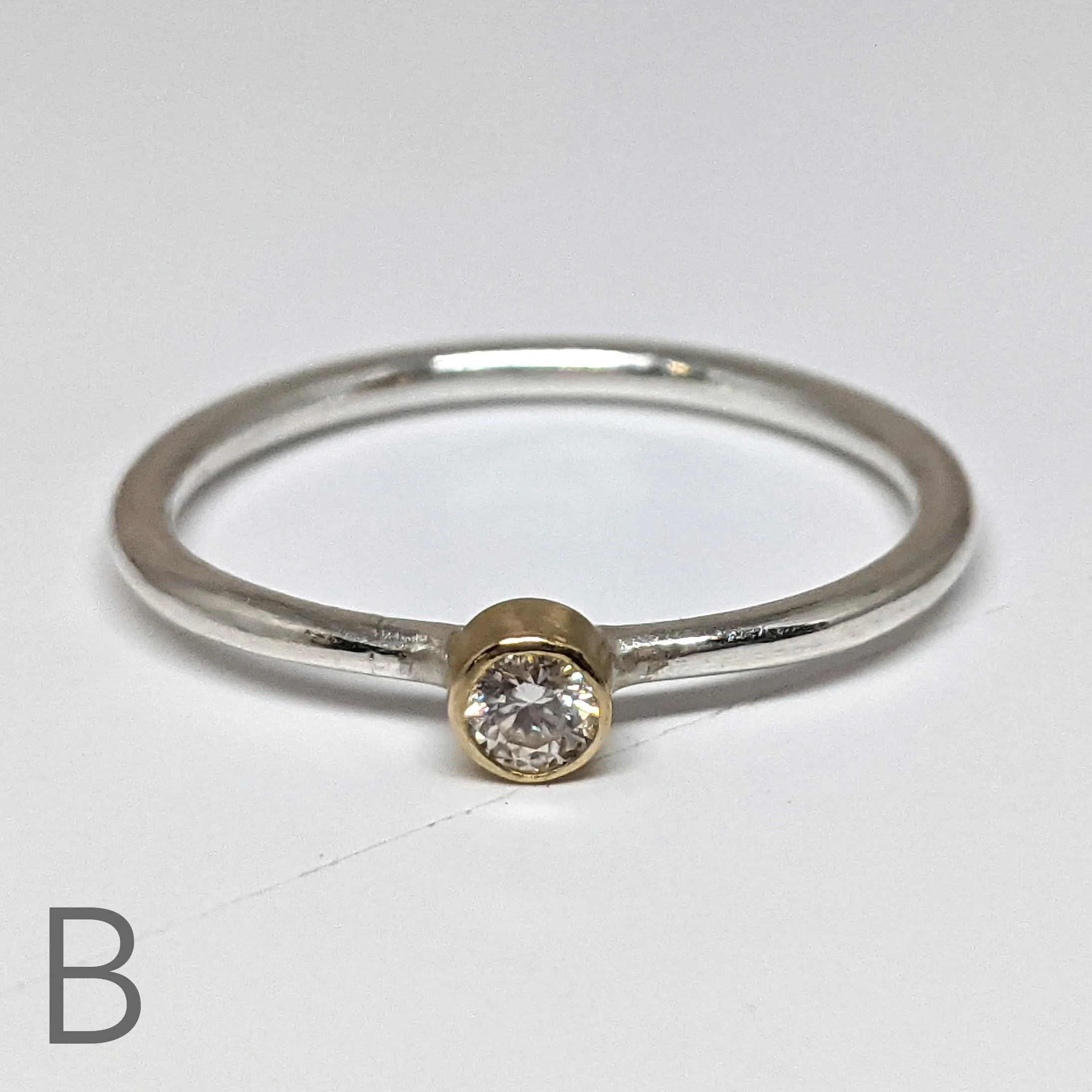 NEW! Moissanite with an 18kt Gold Bezel on a Sterling Silver Stacking Rings by Thea Izzi